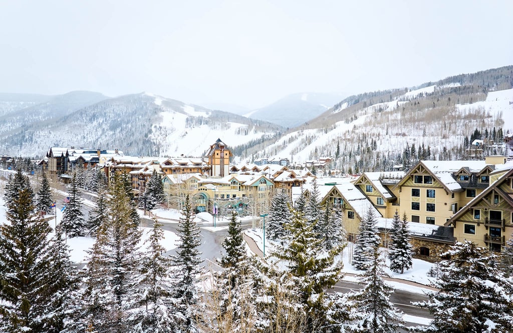 Winter in Vail with snowy town and mountains, with The Sebastian Vail visible in the center