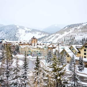 Winter in Vail with snowy town and mountains, with The Sebastian Vail visible in the center