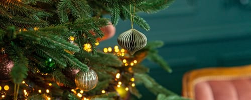 Christmas background, Christmas tree with festive balls and decorations, magic bokeh lights. Copy space, soft selective focus.