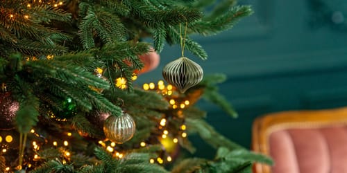 Christmas background, Christmas tree with festive balls and decorations, magic bokeh lights. Copy space, soft selective focus.