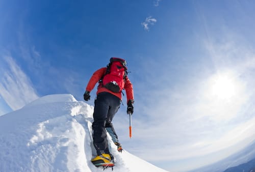 Climber on a snowy ridge, Horizontal frame.