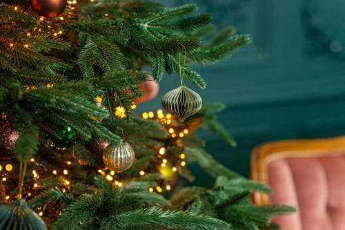 Christmas background, Christmas tree with festive balls and decorations, magic bokeh lights. Copy space, soft selective focus.